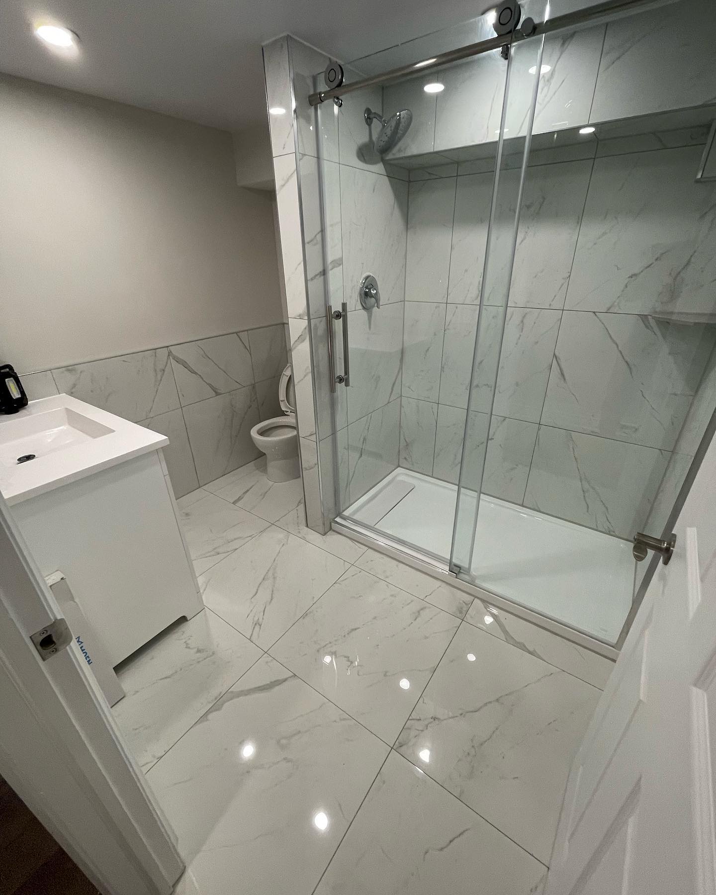 Completed bathroom renovation with coordinated tile, fixtures, and finishing