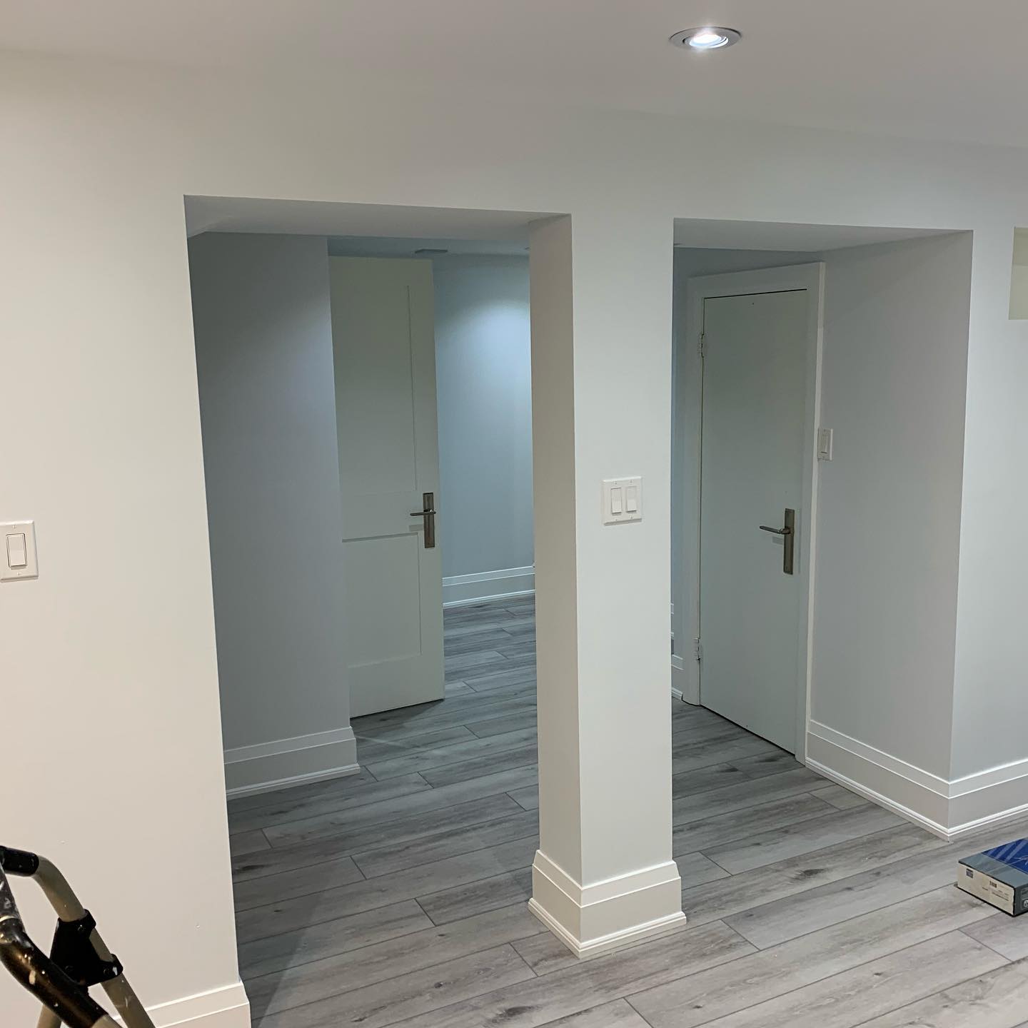 Finished basement layout with new flooring and interior doors