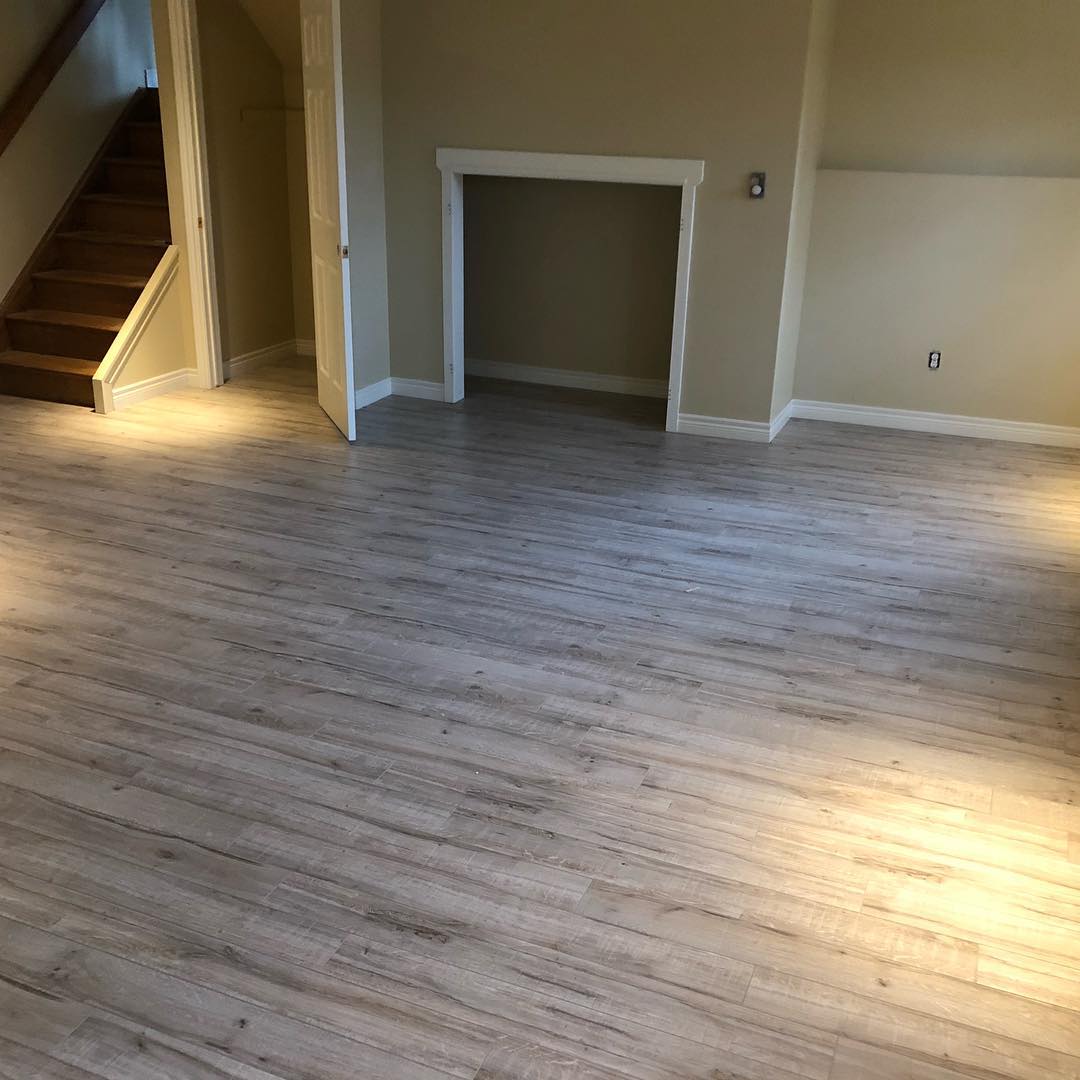 Open basement living area with new laminate flooring